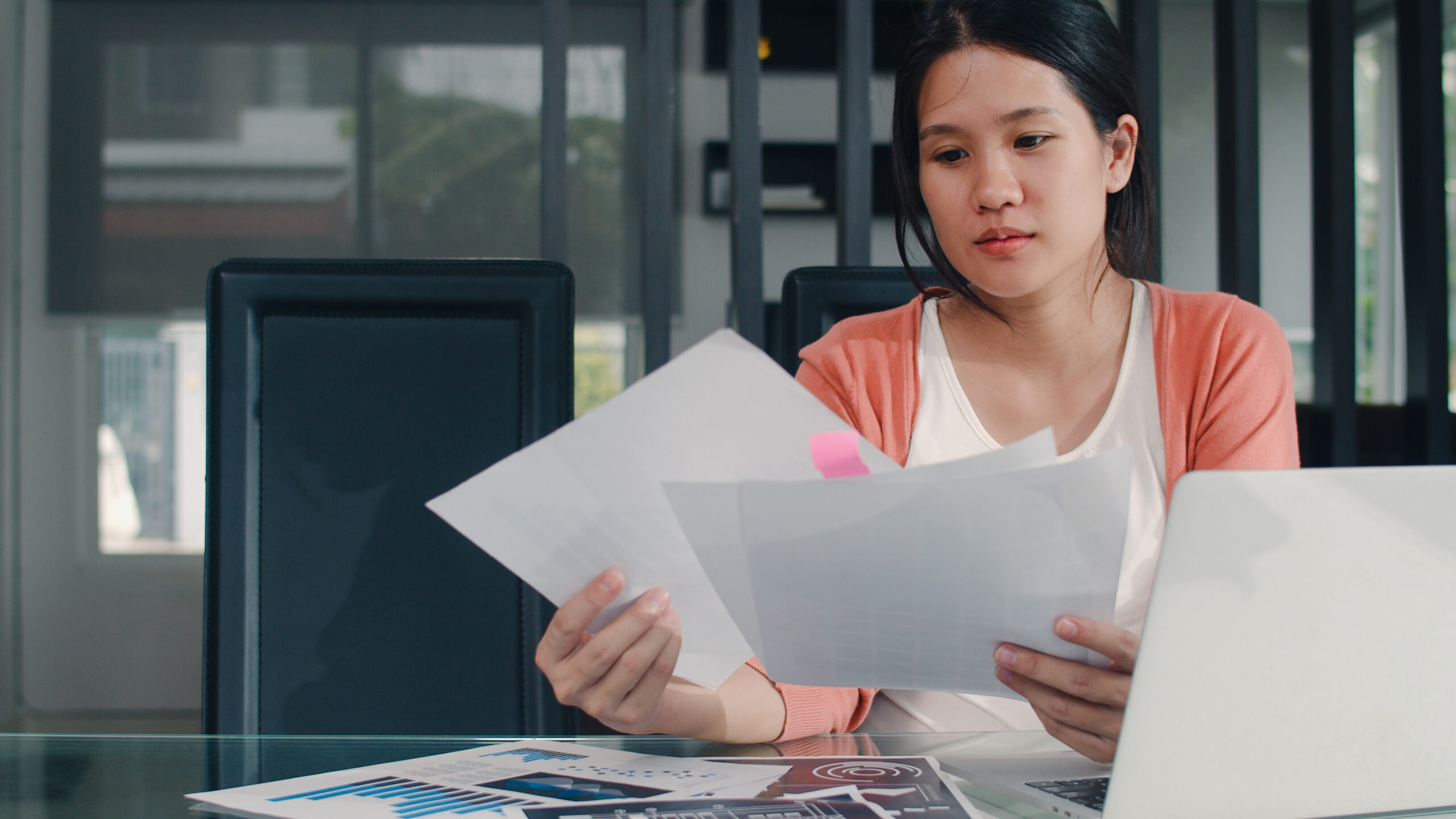 Singapore Best Personal Loans for Foreigners & Expats (2025) 3 Young Asian Pregnant woman records of income and expenses at home. Mom girl happy using laptop record budget, tax, financial document, e commerce working in living room at home concept.