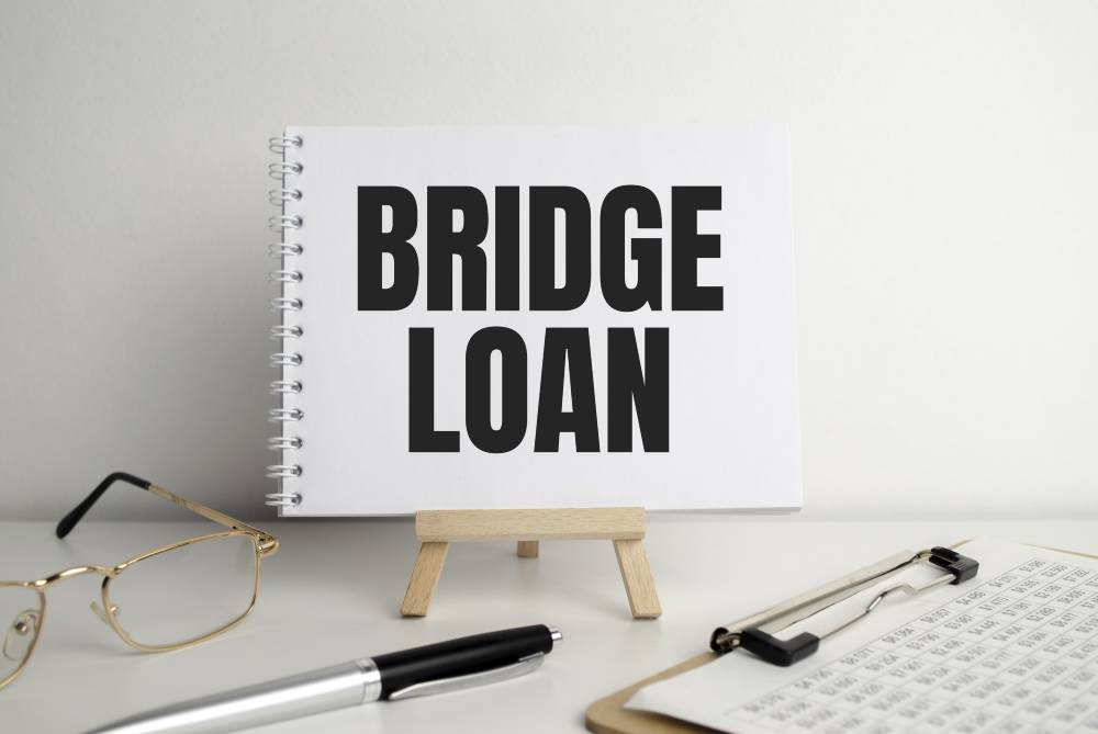 business concepttext bridge loan writing paper pen glasses documents